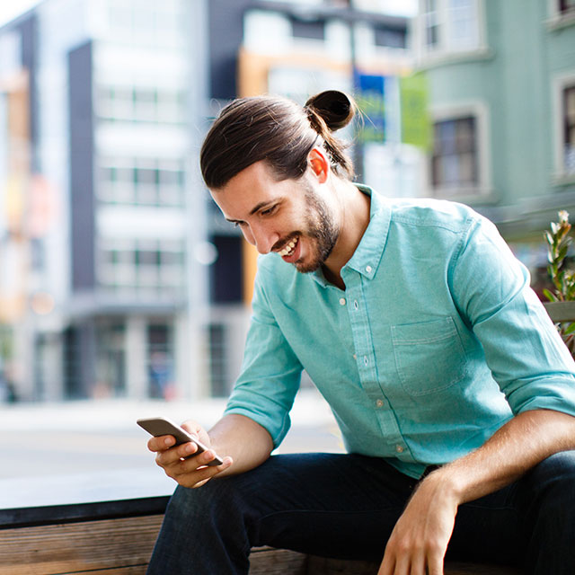 Person sitting on bench using phone